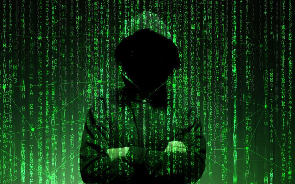 Hooded silhouette hacker surrounded by green code rain, implying cyber hacking.